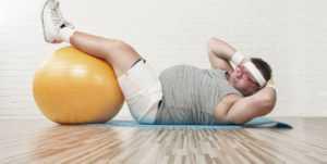Get healthy by talking to your chiropractor A man working out on an exercise ball after receiving treatment at TruSpine in San Francisco, CA